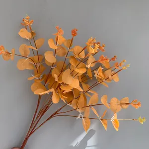 High-quality detail of artificial orange eucalyptus branches with realistic leaf textures