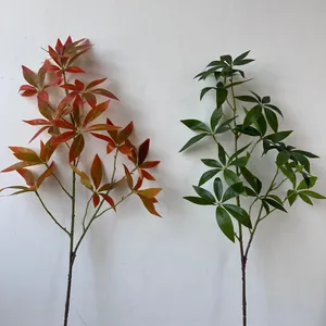 Detailed view of artificial fortune tree leaf branches in vibrant green and autumn orange.