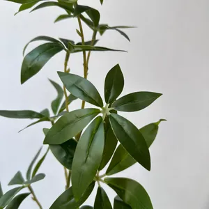 Close-up of realistic artificial green money leaves with natural leaf texture for decor