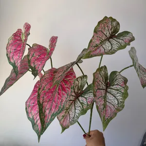 Detailed view of 3D printed artificial Caladium leaves with pink and green patterns.