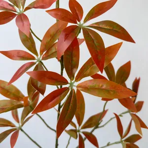 Detailed close-up of artificial autumn-colored Money Tree leaves for home decor.