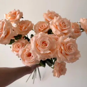 Close-up of artificial champagne roses with realistic water droplets for wedding decor