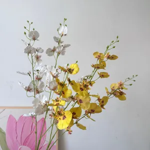 Detail view of artificial white and yellow dancing lady orchids for home decor