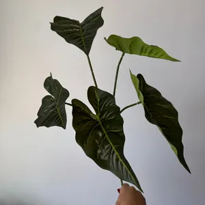 Macro view of 5-forked artificial Alocasia leaves featuring vibrant green textures