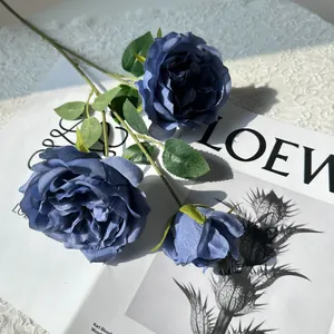 Detail view of high-quality artificial blue Austin roses on a stylish magazine background