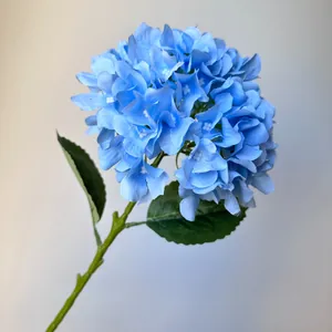 Detailed close-up of a realistic blue artificial hydrangea flower stem for wedding decor