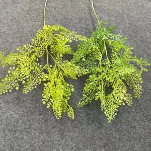 Detailed view of two shades of artificial fern leaves for wedding decoration