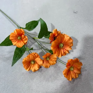 Detailansicht von sechs leuchtend orangefarbenen Kunstblumen mit grünen Blättern.