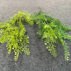 Detail view of light and dark green artificial foliage sprigs for wedding decor