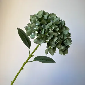 Close-up detail of a single sage green artificial hydrangea stem for wedding decor