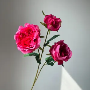 Close-up detail of three vibrant pink artificial Austin roses on a single stem.