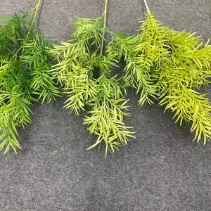 Close-up of artificial green forest-style leaves in three varying shades of green.