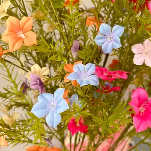 Detailed macro view of colorful artificial periwinkle and wild flowers for decor