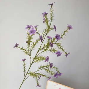 Detailed view of a purple artificial Vinca flower branch with realistic green foliage.