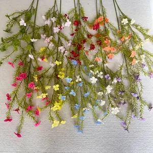 Detailed view of colorful artificial long-branch periwinkle flowers for wedding decor