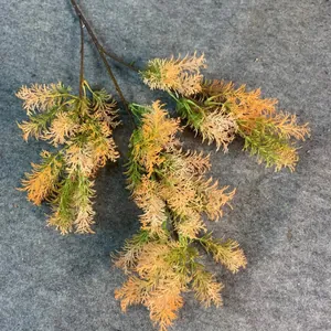 Detailed view of a 3-prong artificial Penglai pine branch with lush green and orange foliage