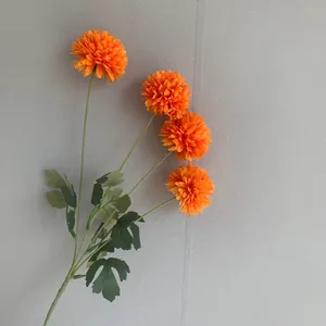 Detailed view of a bright orange 4-head artificial pompon chrysanthemum flower for decor