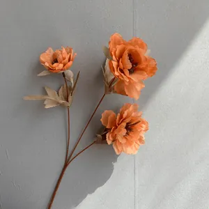 Close-up detail of orange 3-head artificial peony flower branch for nordic style wedding decor