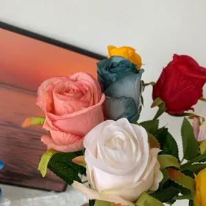 Detail macro view of multi-colored realistic artificial silk Bulgaria roses for home decor