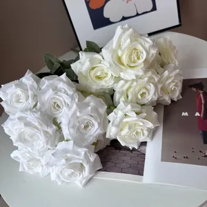 Close-up detail of realistic white silk 9-head diamond roses for home wedding decor.