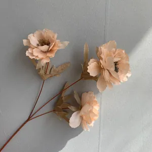 Detailed view of artificial three-head peony silk flowers in apricot for wedding decoration