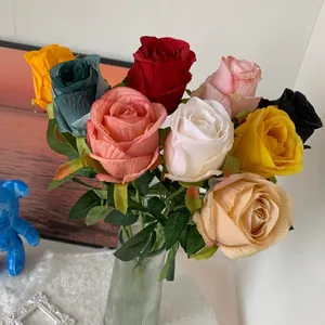 Detailed close-up of vibrant artificial Bulgarian roses in a stylish ribbed glass vase