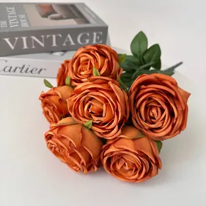 Detailed view of 7-head artificial rose bouquet in burnt orange for wedding decor