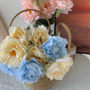 Macro detail of high-quality artificial peony bouquet displayed in a rustic hand-woven basket