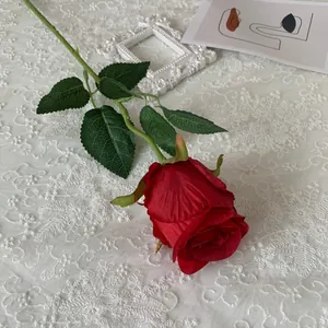 Detailed view of a realistic red silk Bulgaria rose for elegant home decoration