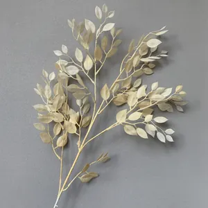 Detailed view of cream-colored artificial banyan leaf branch for elegant wedding decoration.