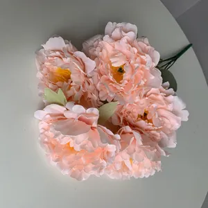 Close-up of five-head artificial peach peony bouquet with realistic layered petals
