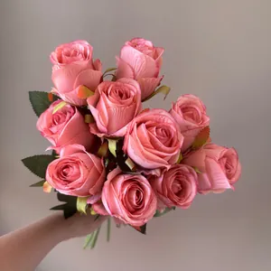 Realistic hand-held bouquet of pink Bulgarian artificial roses for home decoration