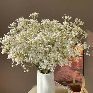 Primer plano de un ramo de paniculata blanca artificial con 108 cabezas en un jarrón blanco