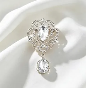 Elegant vintage court style silver brooch featuring a sparkling crystal teardrop pendant