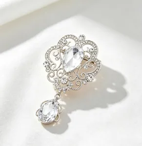 Close-up of elegant palace style brooch with rhinestones and teardrop crystal pendant