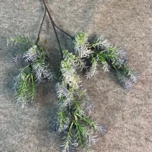 Detailed view of artificial Penglai pine branch with frosted green foliage texture