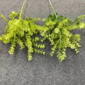 Detail view of artificial forest greenery with intricate green foliage for wedding decor