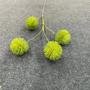 Detail of artificial green pom-pom flower stem with four heads for wedding decor