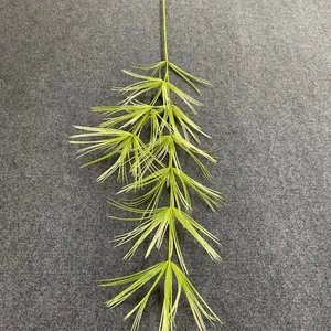 Macro detail of artificial yellowish-green pine foliage branch for wedding decor