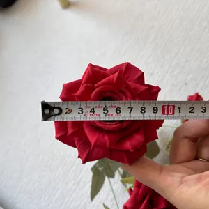 Detailed macro view showing the diameter measurement of a realistic red silk rose head