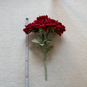 Close-up detail of 7-head red artificial silk roses with measuring tape showing size