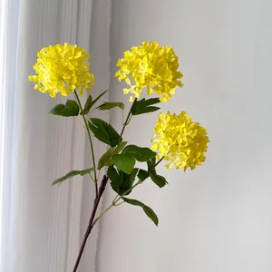 Detail view of 3-head artificial yellow hydrangea snowball flowers with green leaves