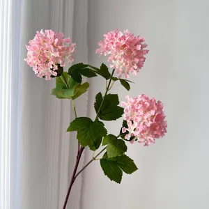 Close-up of pink 3-head artificial hydrangea flowers with realistic green leaves