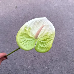 Close-up detail of a white and green gradient artificial Anthurium flower for wedding decor