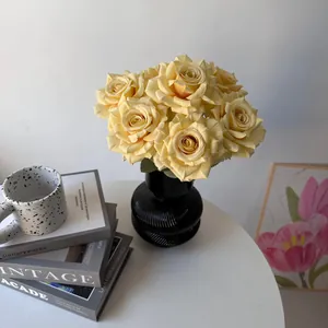 Detailed view of 7 yellow artificial roses in a black vase for stylish home decoration