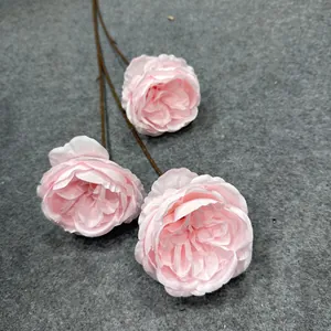 Vista dettagliata di rose Austin artificiali rosa con tre teste di fiori di seta