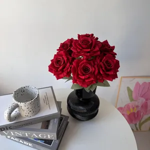 Elegant 7-head red silk roses in a black ribbed vase on a minimalist white table