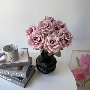 Detail of a 7-head artificial silk rose bouquet in a black vase for elegant home decoration.