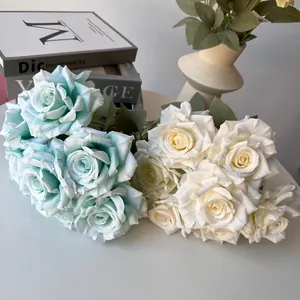 Close-up of artificial silk roses in light blue and cream white for home decor