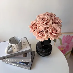 Detailed macro view of 7-head dusty pink silk roses arranged in a black ceramic vase